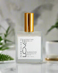 A bottle of Self Talk Dry Body Oil Mist with a white label and gold-colored cap.