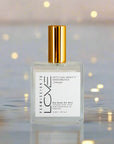 champagne dry body oil mist bottle with gold cap on a white background