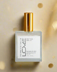 A bottle of Self Talk Dry Body Oil Mist with a white label and gold-colored cap.