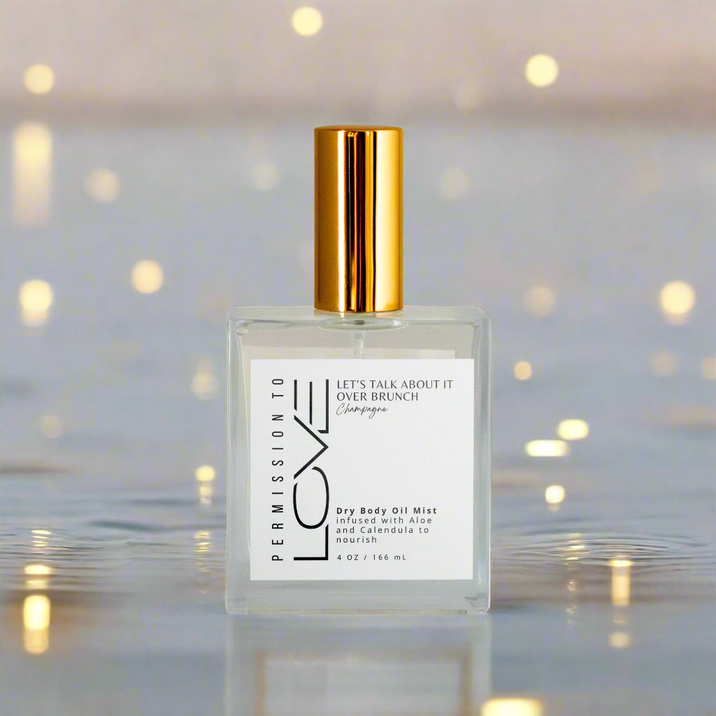 champagne dry body oil mist bottle with gold cap on a white background
